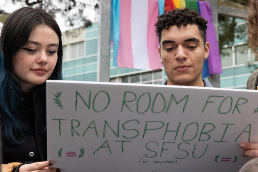 Meg Harrington (L) and Isaac Barajas make a sign to protest a Turning Point USA event named “Saving Women’s Sports” at SF State in San Francisco, Calif., on Thursday, April 6, 2023. Swimmer Riley Gaines is the feature speaker at the conservative groups event and known to be critical of transgender participation in women sporting events. (Benjamin Fanjoy/ Golden Gate Xpress)