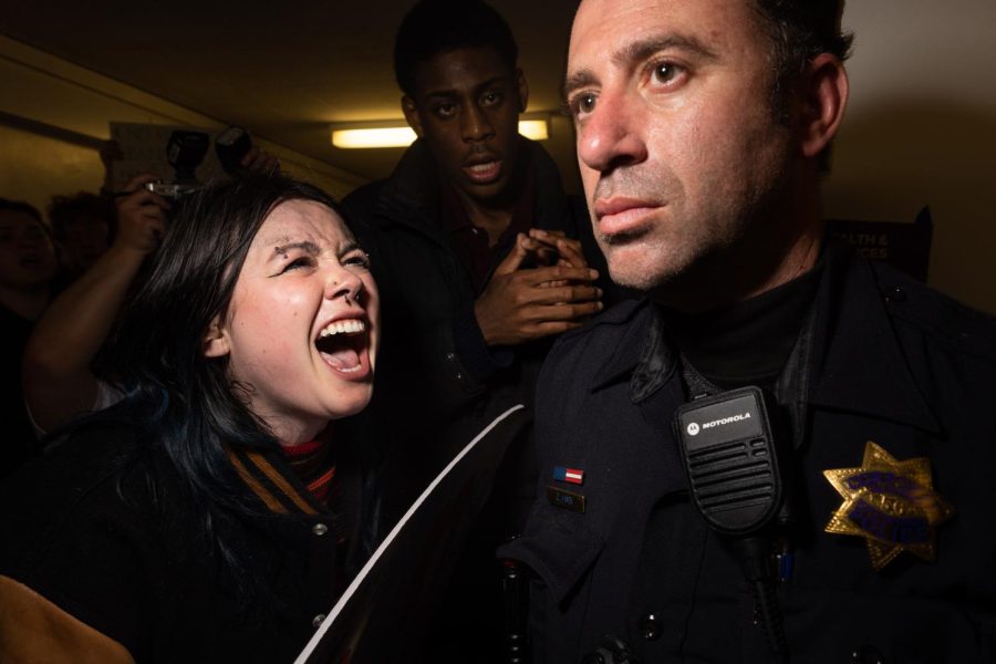 Meg Harrington confronts police as they guard Riley Gaines from protesters at SF State in San Francisco, Calif., on Thursday, April 6, 2023. Swimmer Riley Gaines was the feature speaker at a Turning Point USA event and known to be critical of transgender participation in women sporting events. (Benjamin Fanjoy / Golden Gate Xpress)