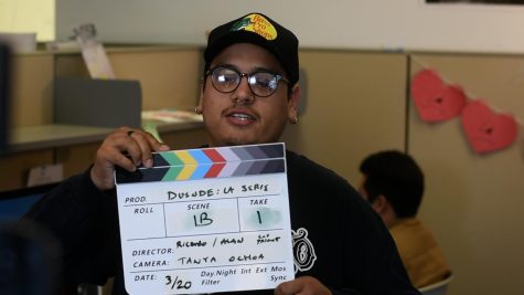 Ricardo Sanchez uses a clapper on the set of Duende inside SF State’s Dream Resource Center on Monday, March 20, 2023. (D’Angelo Hernandez / Golden Gate Xpress)
