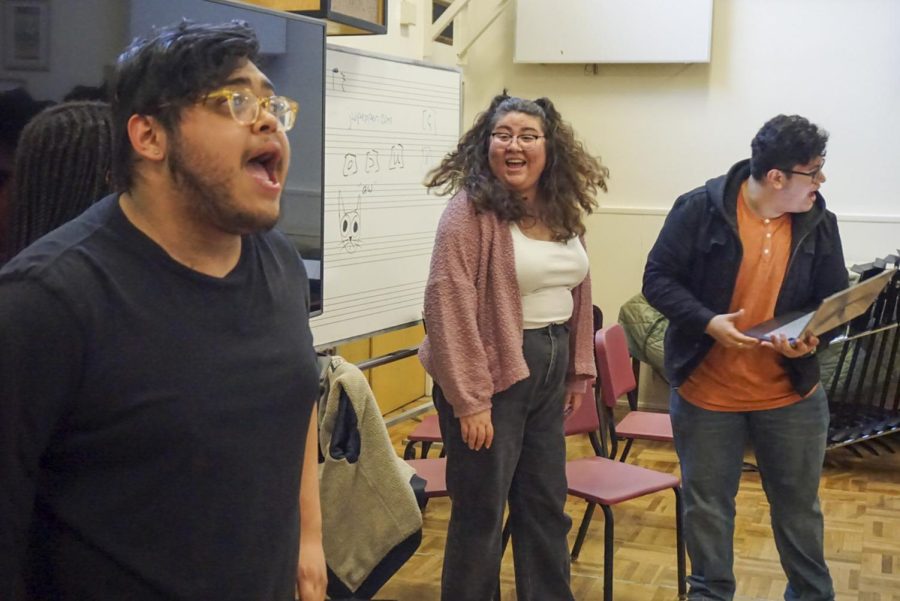 From left to right, ensemble members Phoenix Vaughn, third year theater major and music minor, Jesus Ovalle, second year biology major and chem and theater arts minors, and Kim Ramos, SF State theater and dance alum, sing during practice of Tan Sang’s original musical  An Artists Love and Success in the Creative Arts building on campus on April 21, 2023. (Tatyana Ekmekjian/Golden Gate Xpress)
