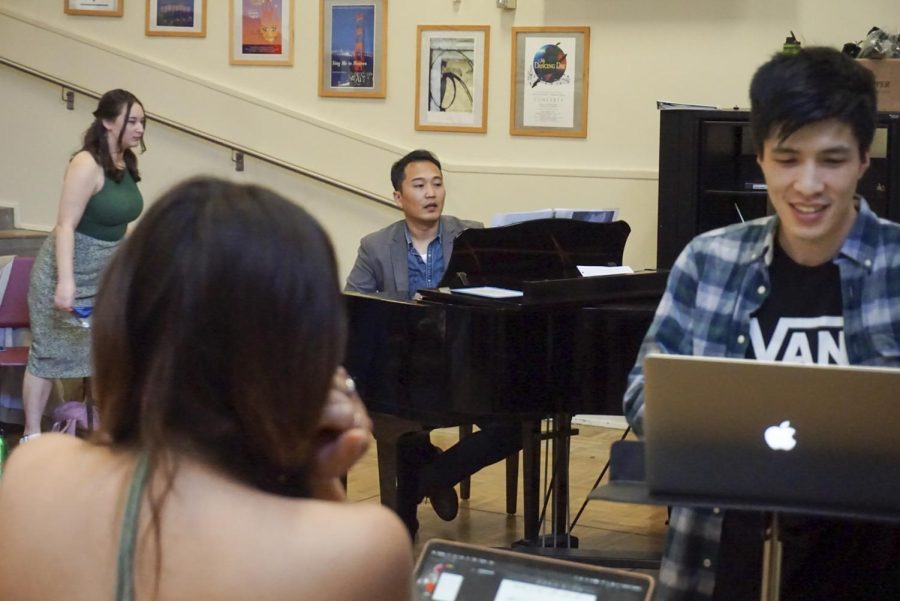 Sitting at the piano, Tan Sang, the composer; director and playwright mastering in music composition, leads play practice while Julia Sussman (L), child adolescent development major playing Rose, and Eric Ye (R), senior music major and lead role, transition to the next scene and song in the Creative Arts building on campus on April 21, 2023. (Tatyana Ekmekjian/Golden Gate Xpress)
