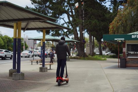 A scooter rider passes by Station Cafe at SF State, situated on 19th and Holloway, where the robbery occurred on the morning of June 7, 2023. (Michaela Mateo / Golden Gate Xpress)