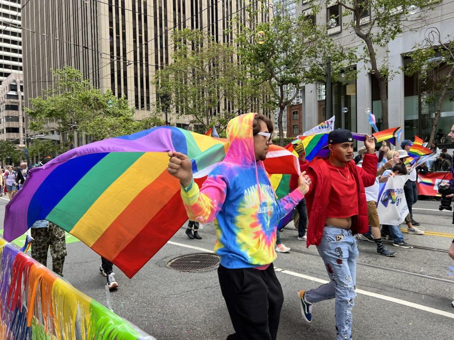 SF Pride Parade members fly the Pride flag while marching in the parade down Market St at SF Pride on June 25, 2023. (Zac Zavala / Golden Gate Xpress)