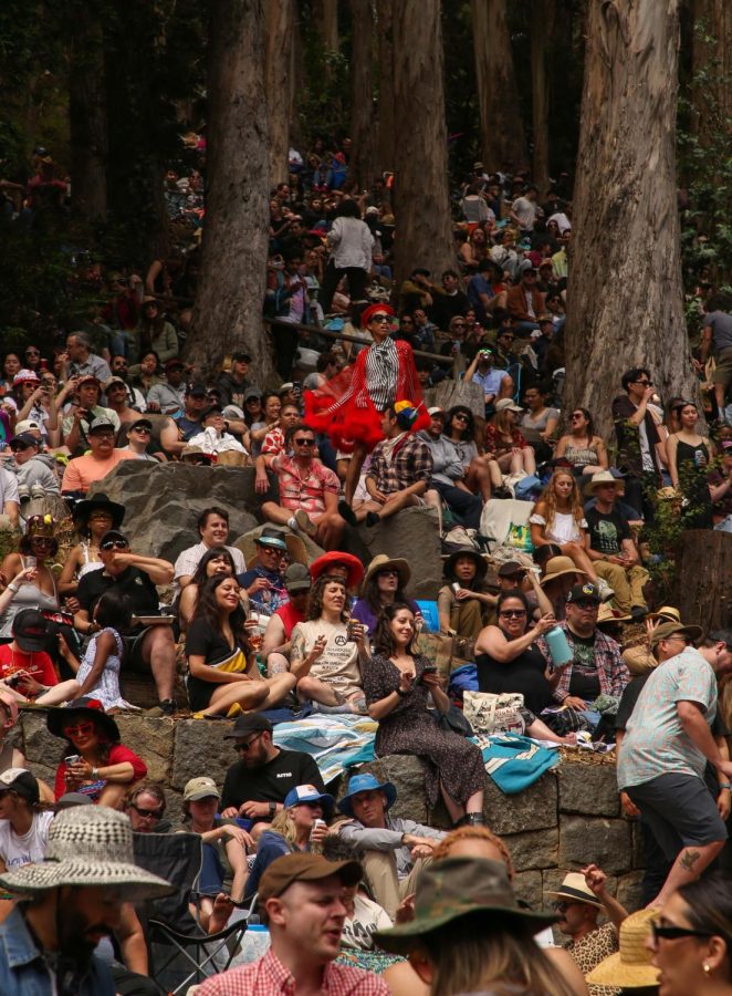 A person dances on an elevated ground amongst their fellow concert-goers while waiting for the show to start at Stern Grove on July 2, 2023. (Tam Vu / Golden Gate Xpress)