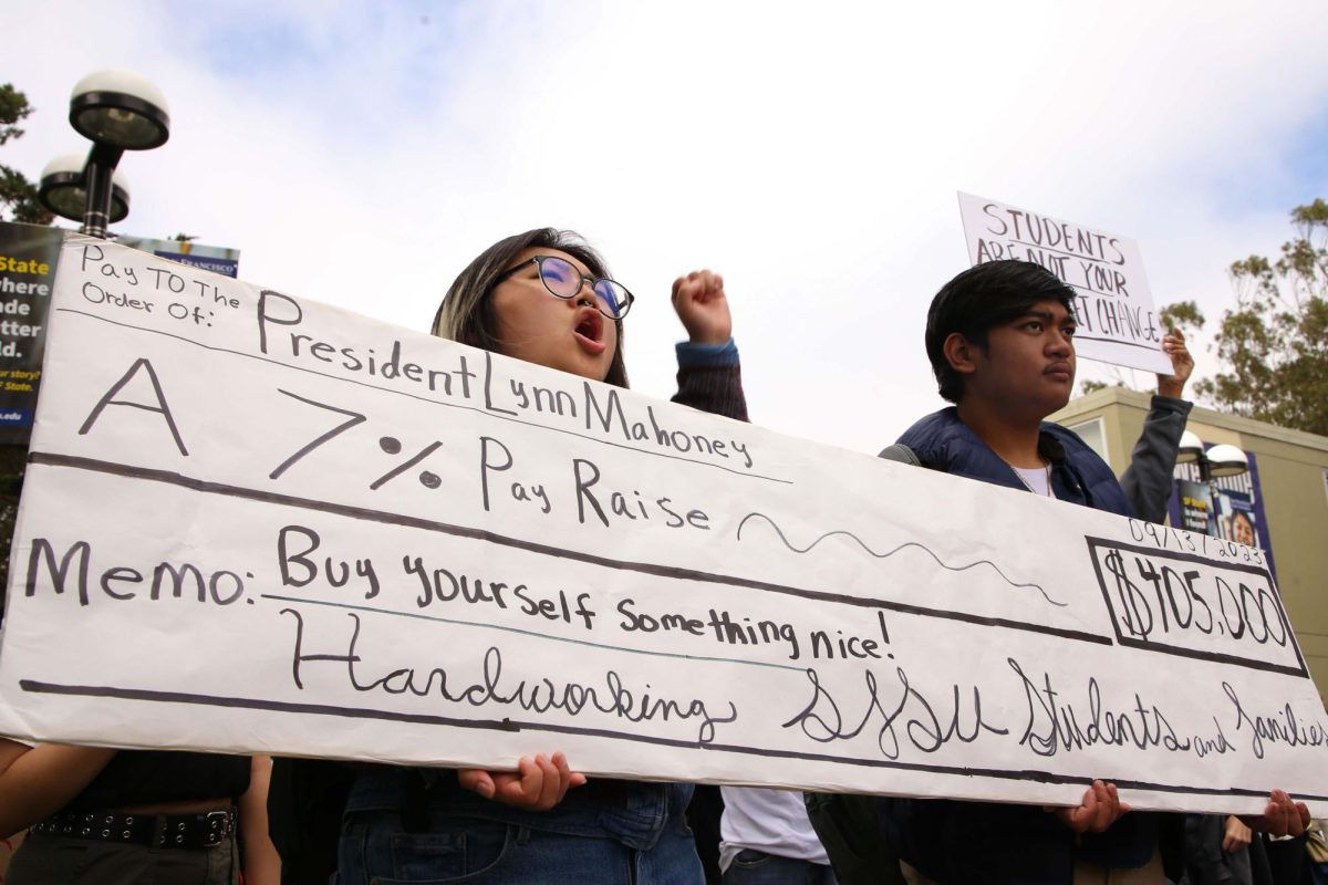 Students raise their signs in unison while expressing their disapproval of the tuition increase proposal on 19th Avenue and Holloway on Sept. 11, 2023. (Tam Vu / Golden Gate Xpress)