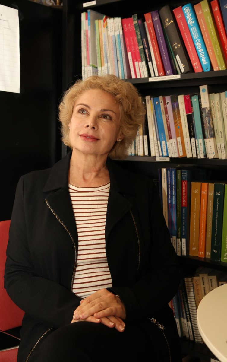 Mitra Ara, professor of Persian Studies, poses in front of a bookshelf in the Persian Center in San Francisco State University on Oct. 17, 2023. (Tam Vu / Golden Gate Xpress) 
