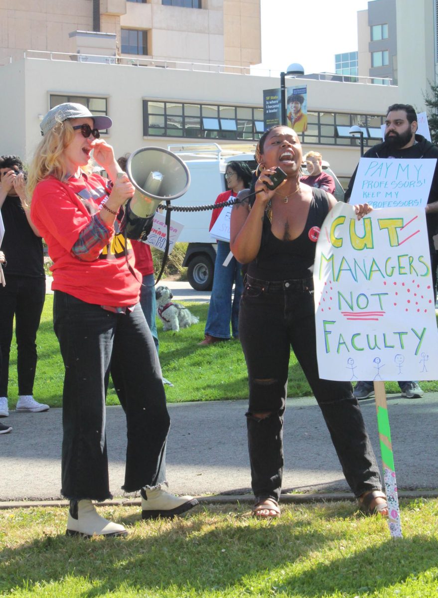 Bonica Bonheur, a transfer student, shouts and holds up a sign at the practice rally at SFSU’s Quad on Wed, Oct. 11 , 2023. (Kayla Williams / Special for Golden Gate Xpress)


