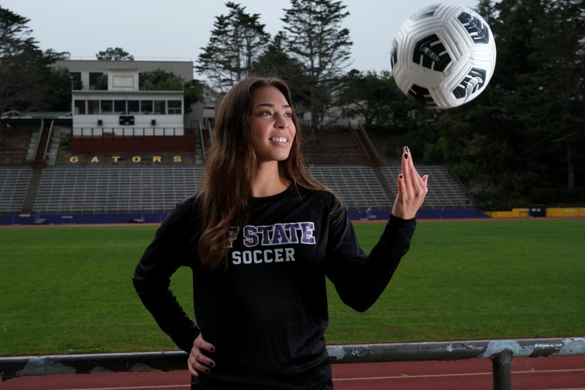 Carissa Capinpin, a senior and captain of the SFSU women’s soccer team, throws a soccer ball in the air during a portrait shoot in Cox Stadium on Tuesday, Oct. 3, 2023. (Andrew Fogel/Golden Gate Xpress)