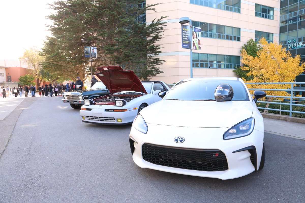 A line-up of cars brought in by the Gator Greasers Automotive Club for their first car show on SF State campus in support of Toys for Tots on Dec. 1 , 2023. (Michaela Mateo / Golden Gate Xpress)
