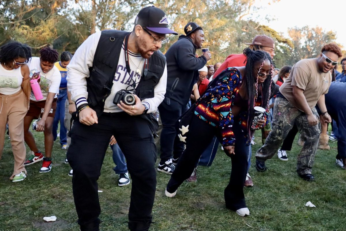 Ryan Webb leads the electric slide accompanied by other attendees at Hippie Hill on Feb. 24 (Adriana Hernandez / Golden Gate Xpress)