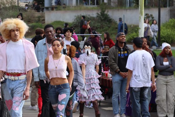 Fashion show participants walk towards the Cesar Chavez center showing off their outfits promoting the venders featured at the event on Feb. 15 , 2024 at SF State. (Adriana Hernandez / Golden Gate Xpress)