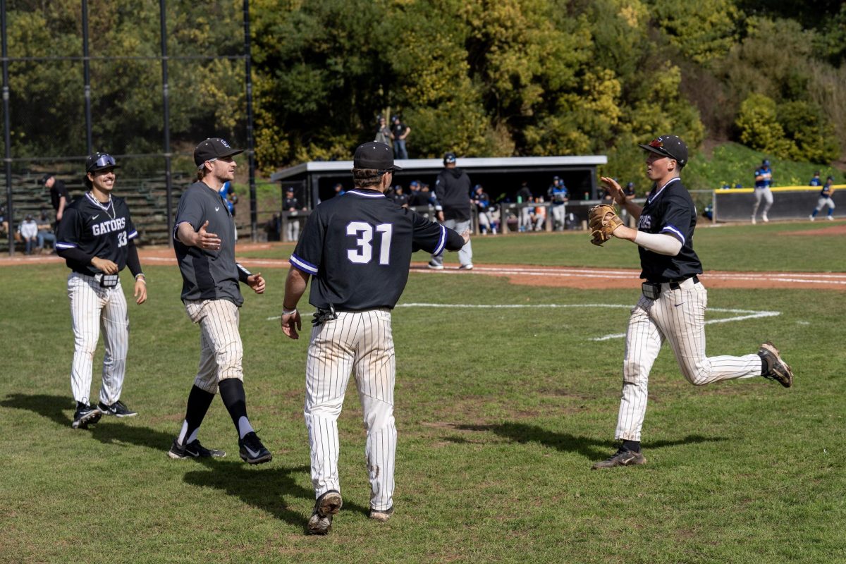 Members of the San Francisco State University baseball team high-five infielder Jacob French (right) after the first inning against Cal State San Bernardino Maloney Field on Friday. (Sean Young / Golden Gate Xpress)