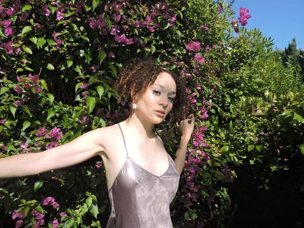 Zoe Nika Reidy-Watts poses in front of a bush. (Courtesy of Edith Mariscal)