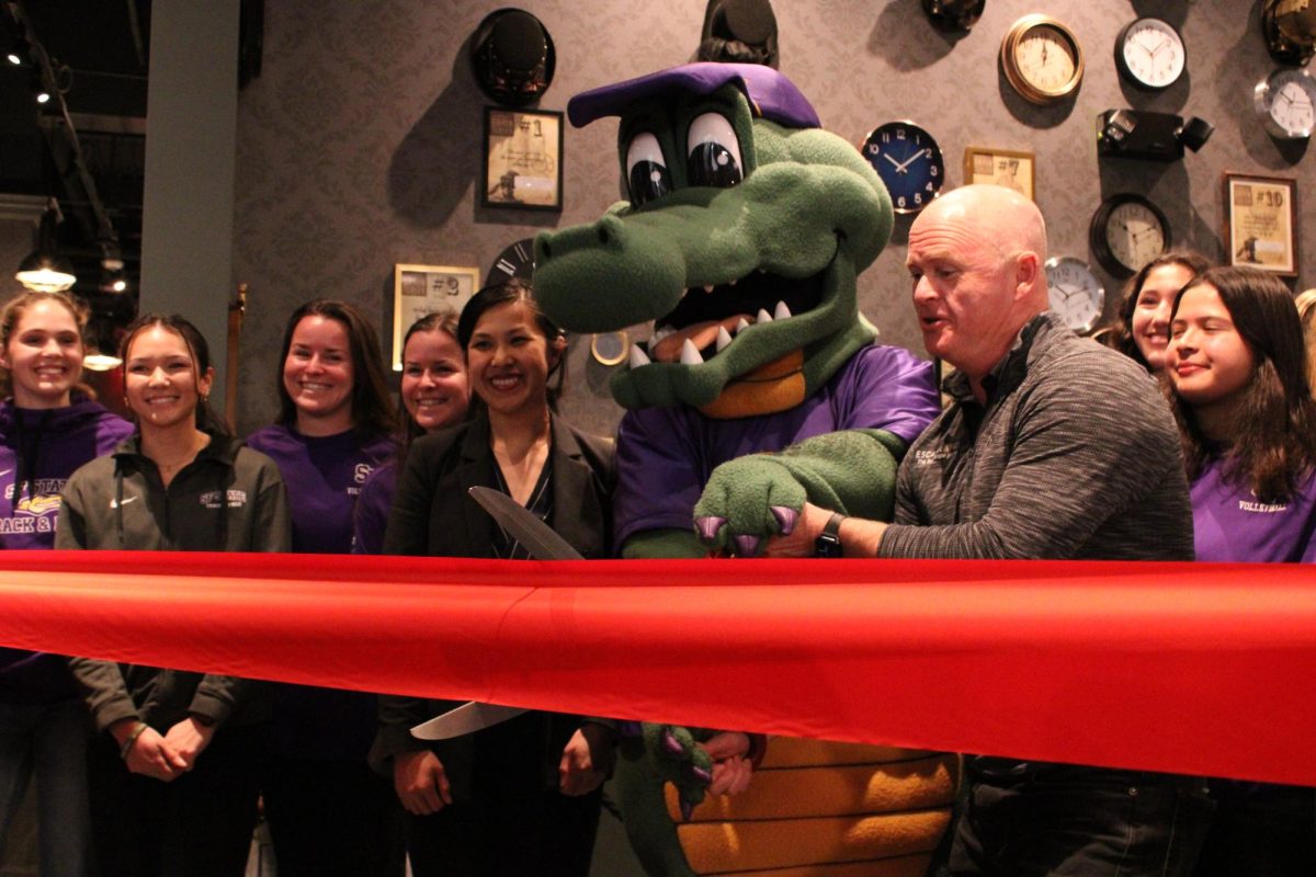 Alli the Gator and Burton Heiss moments before cutting the ceremonial ribbon at the opening of Escapology at Stonestown on Feb. 29, 2024. (Luke Cramer/Golden Gate Xpress)