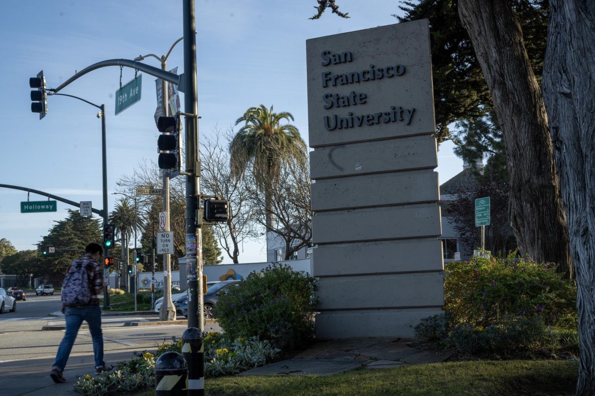 A student walks past the entrance to San Francisco State University at 19th Avenue and Holloway Avenue on March 13, 2024. (Sean Young / Golden Gate Xpress)