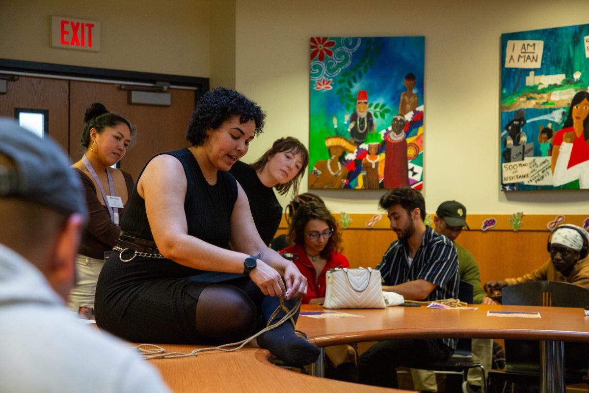 Ivy Limieux (center left) ties their ankle while leading a rope bondage workshop in collaboration with the Education and Referral Organization for Sexuality at the Richard Oakes Multicultural Center on March 15, 2024. (Dan Hernandez / Golden Gate Xpress)
