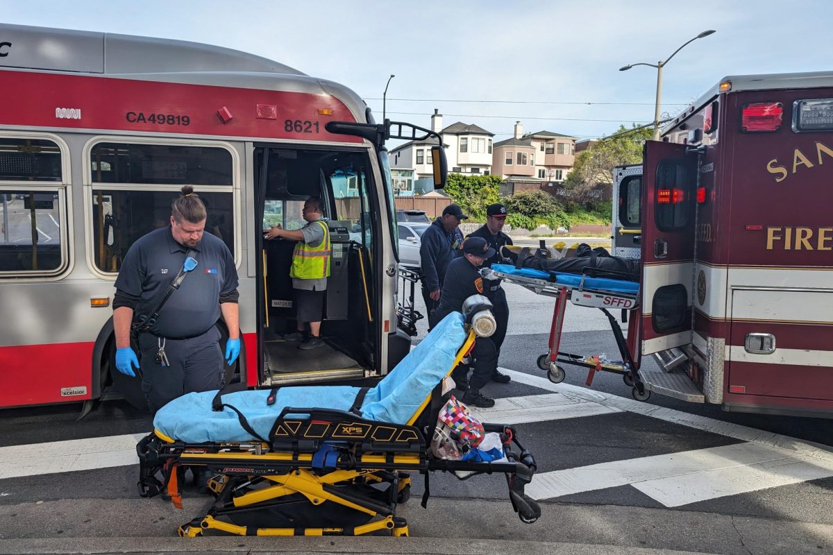 Paramedics and firefighters move one of the injured passengers into an ambulance while another stretcher is prepared for the second passenger who needed to be transported to a hospital on April 10, 2024. (Neal Wong / Golden Gate Xpress)