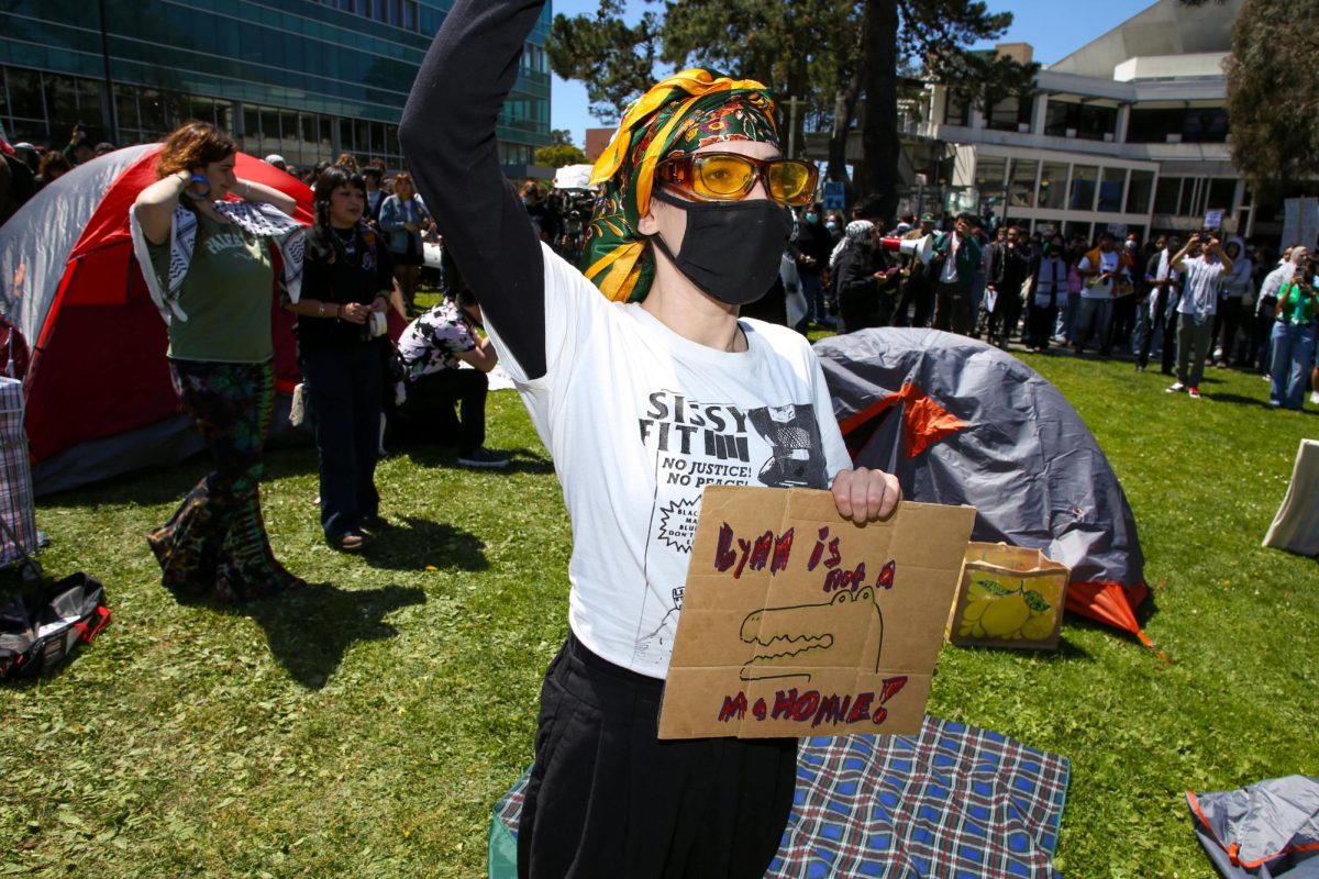 At the quad, a camper holds up a sign, which reads “Lynn is not a MaHOMIE!” in reference to SFSU President Lynn Mahoney in the quad on Monday, April 29, 2024. (Tam Vu / Golden Gate Xpress)