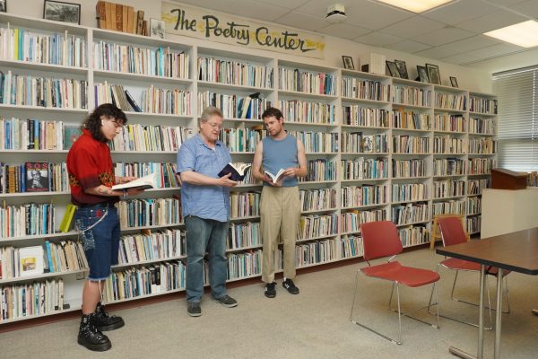 Tatihn Mellieon, Steve Dickinson, and Thomas Ziemer pose for a photo in the Poetry Center reading room on April 10, 2024. (Neal Wong / Golden Gate Xpress)