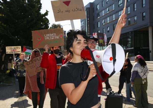 Rally participants lead chants, requesting that SFSU administration meet their demands, outside the Administration Building on May 7, 2024. (Tam Vu / Golden Gate Xpress) 