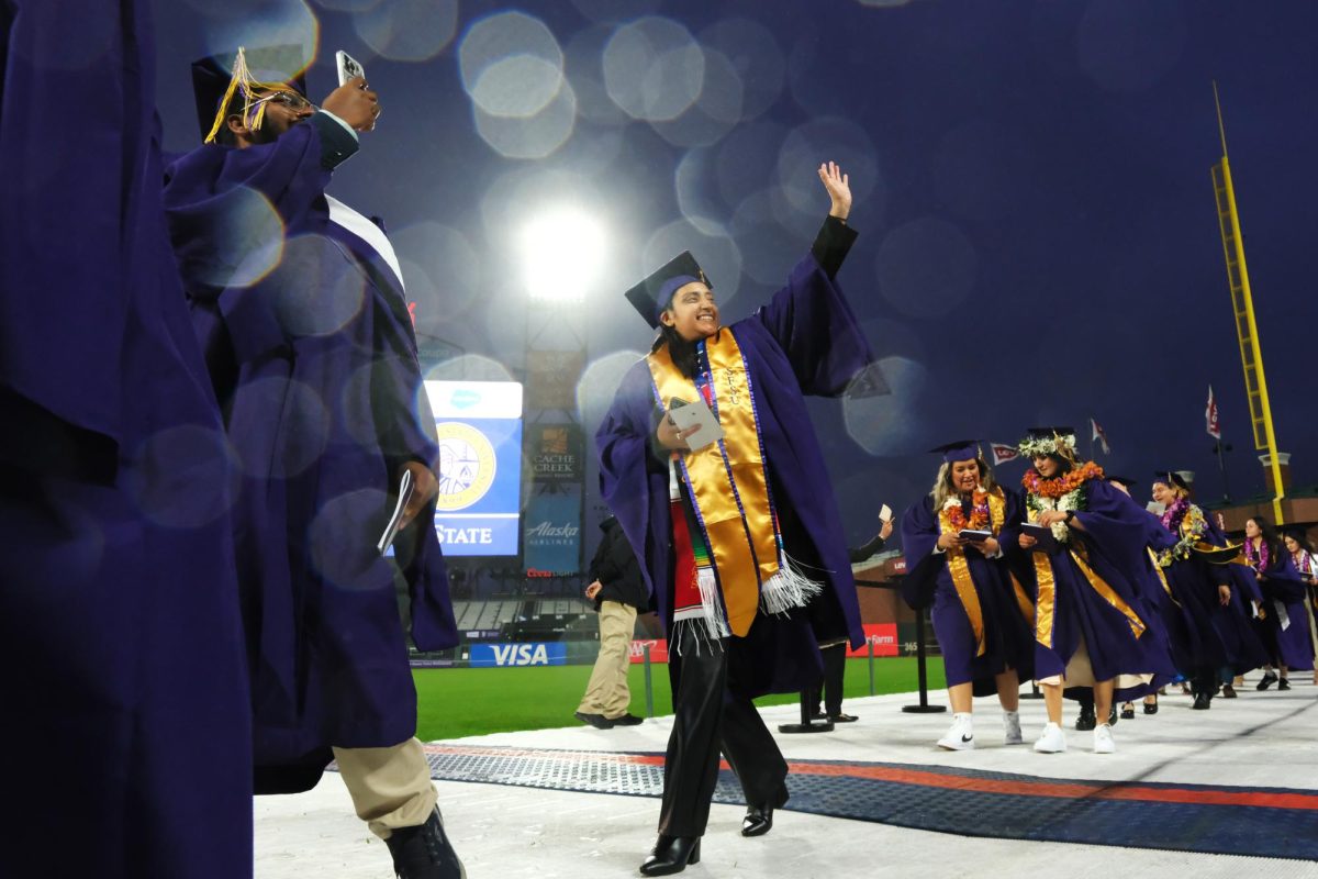 Graduates walk to receive their diplomas at SFSU’s commencement at Oracle Park on Friday, May 24, 2024. The weather varied throughout the ceremony, with small raindrops and gusts of wind occasionally being felt. (Andrew Fogel / Golden Gate Xpress)
