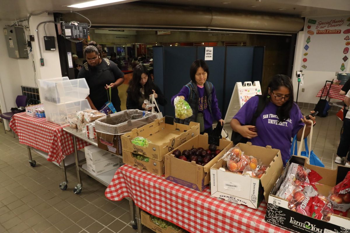 Students browse and pick from the produce options at the AS Food Pantry in the Cesar Chavez Student Center on Tuesday, Sept. 3, 2024. The pantry is also the location for Gator Groceries on Thursdays and Fridays. (Gabriel Carver / Golden Gate Xpress)