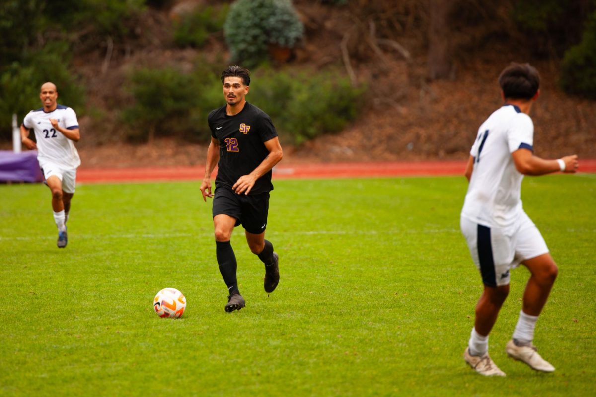 SF State Men’s Soccer forward Angel Herrera (12) advances the ball while playing  against California State University, Monterey Bay at Cox Stadium on Saturday, Sept. 28, 2024. The Gators lost to the Sea Otters after a fast-paced physical game and fall to 0-4-2 on the season. (Jesus Arriaga / Golden Gate Xpress)