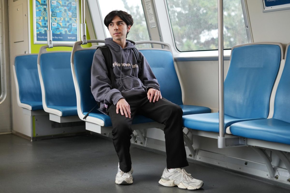 Kevin DeAntoni poses for a portrait on a BART Blue Line train heading to Dublin/Pleasanton on Sept. 11, 2024. DeAntoni’s interest in BART grew after riding it frequently to see his boyfriend. (Andrew Fogel / Golden Gate Xpress)
