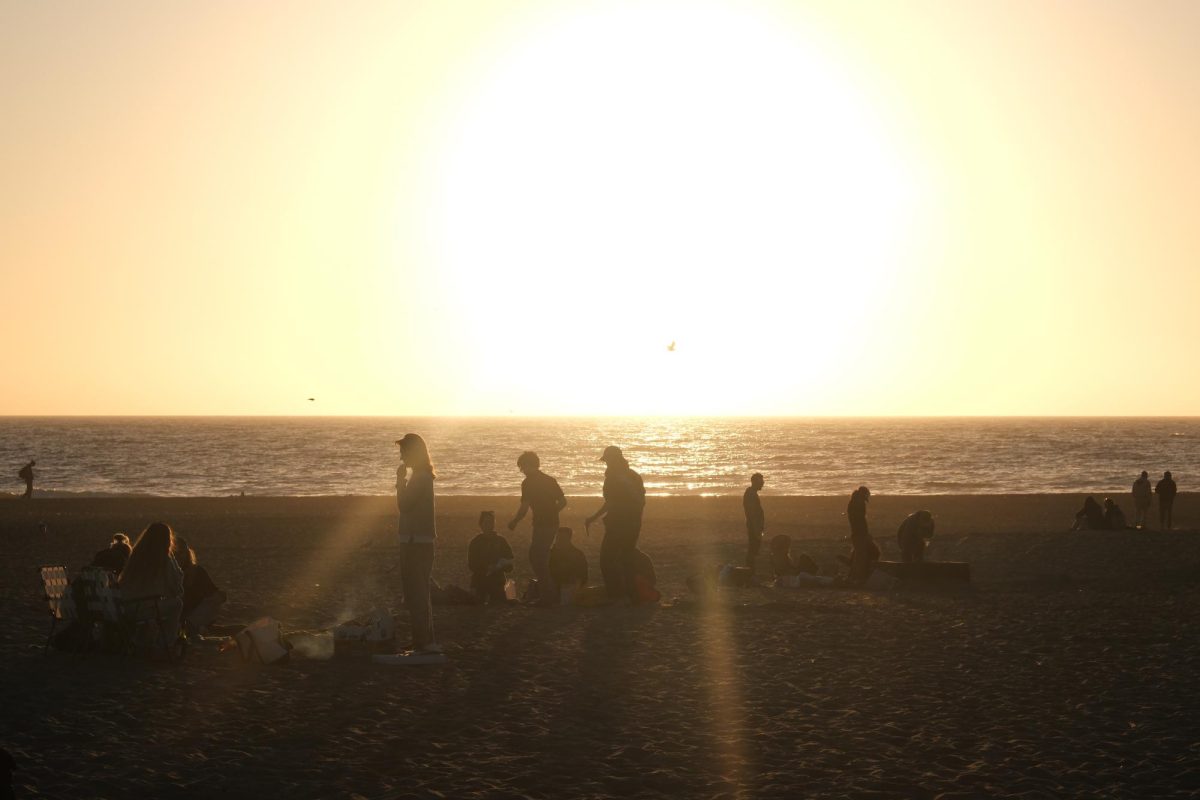 People hang out during sunset at Ocean Beach on Friday, Aug. 29, 2024. Despite some initial hiccups, the bonfire hosted by Student Activities & Events eventually took place. (Andrew Fogel / Golden Gate Xpress)