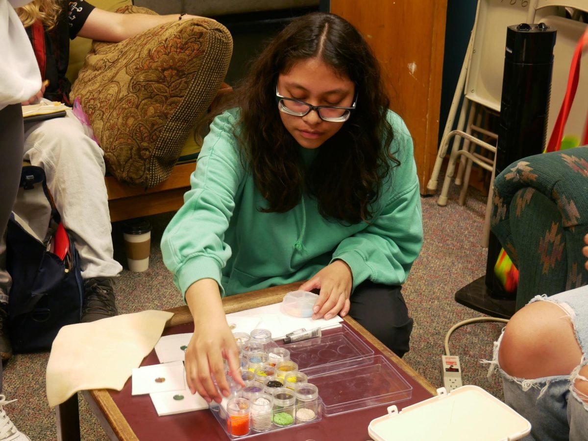 Sandra Garcia selects beads for her project at the  Student Kouncil of Inter-Tribal Nations (SKINS) beading circle event on Monday, Sept. 23, 2024. (Anessa Bailon / Golden Gate Xpress)