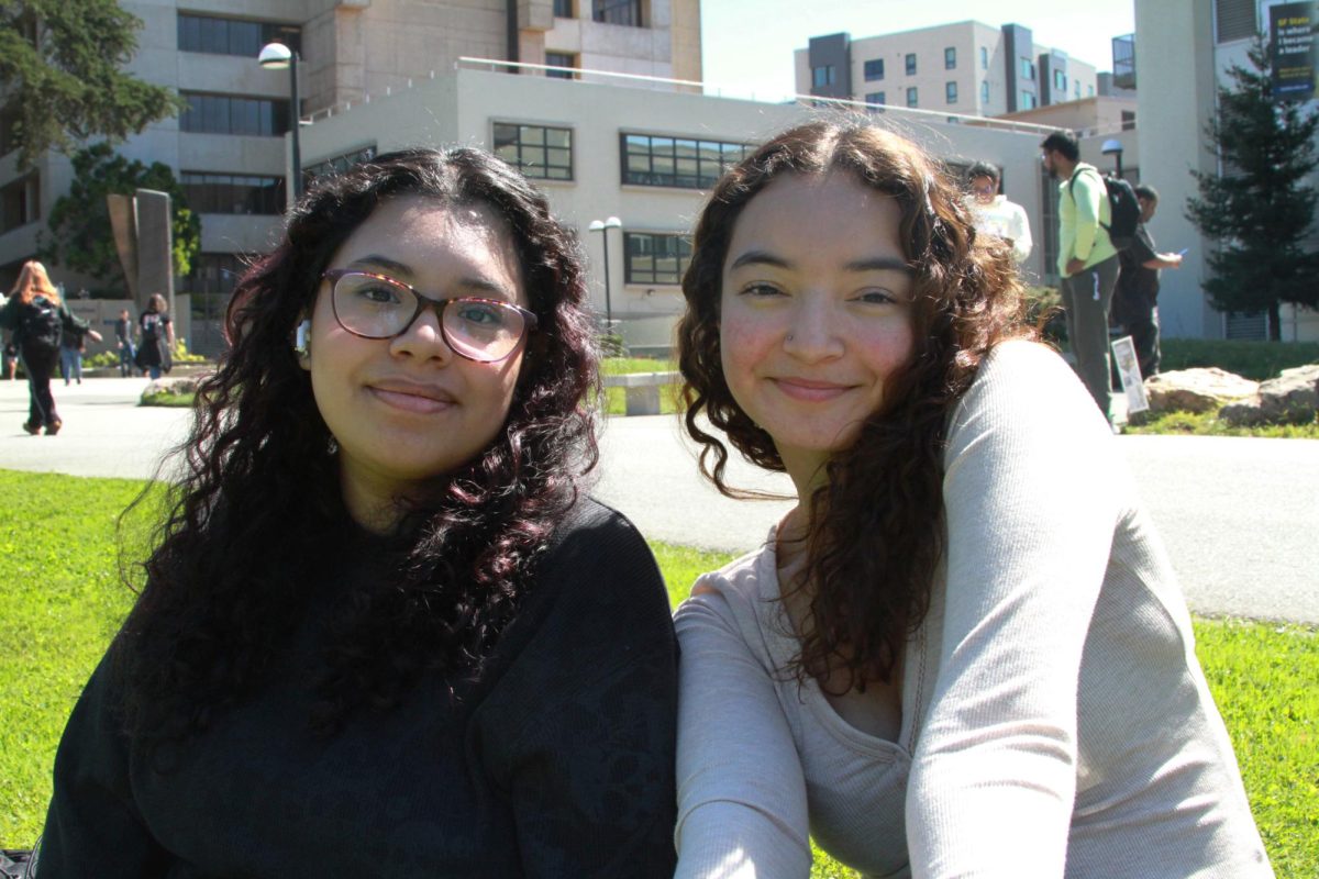 Two freshmen at San Francisco State University, Kaylee Ortiz (L) and Fernanda Cruz (R), pose for a portrait outside of the J. Paul Leonard Library on Wednesday, Sept. 25, 2024. Ortiz and Cruz said they try not to get news from social media. (Paula Sibulo / Golden Gate Xpress)