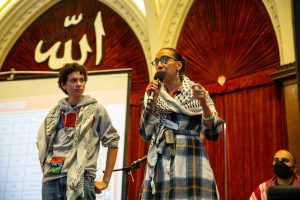 (L-R) Sohrab Ford, Students for Gaza SFSU organizer, and Rama Ali Kased, associate professor in Race and Resistance Studies, speak to an estimated 340 people at the Bay Area Popular Convention for Palestine inside the Islamic Cultural Center of Northern California in Oakland, Calif. on Sept. 15, 2024. (Dan Hernandez / Golden Gate Xpress)