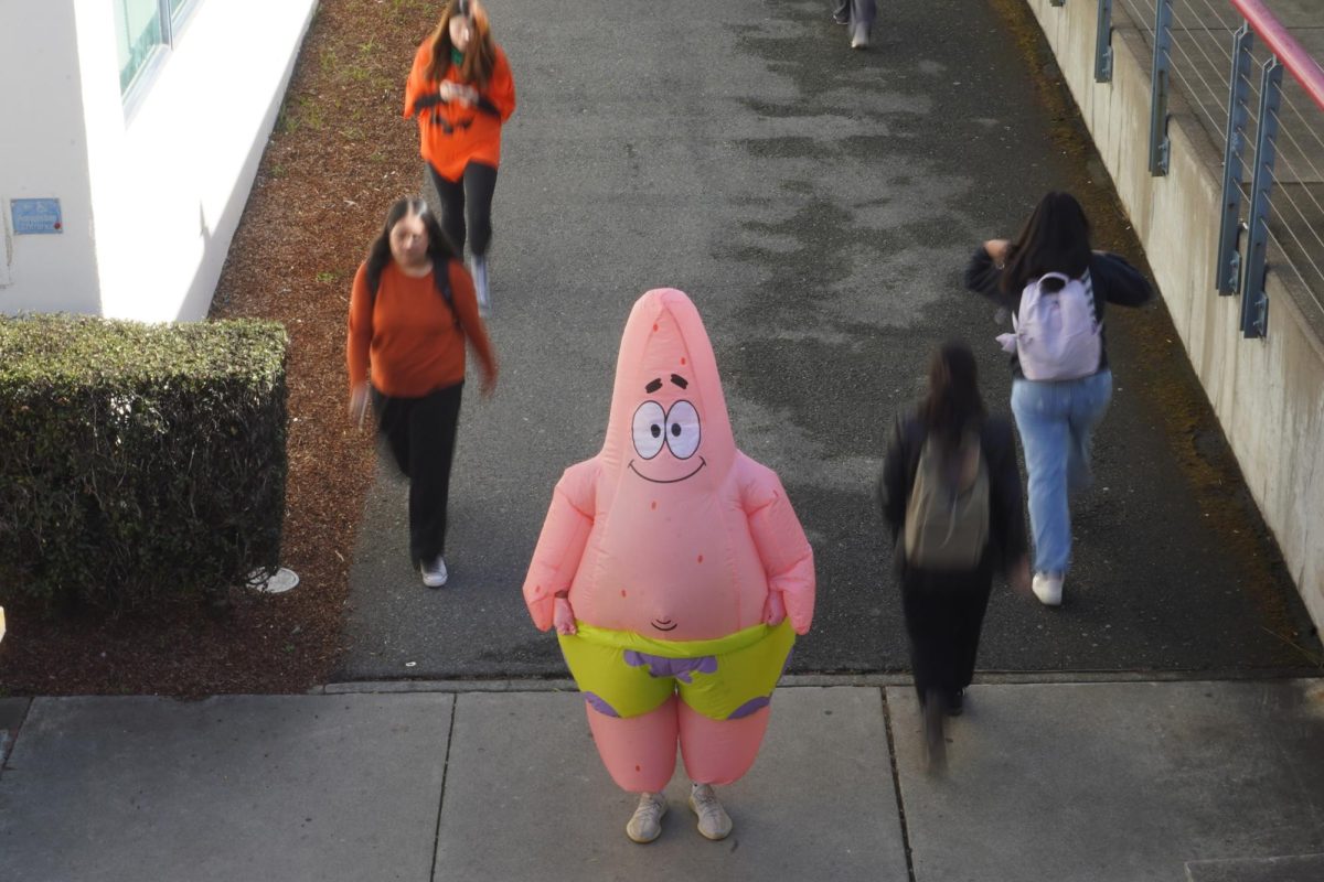 Adrian Tejada, a first-year cinema student, stands for a photo as Patrick from “SpongeBob Squarepants” on October 31, 2024. He said he chose this costume because he was interested in SpongeBob ever since he was a child and saw the costume at Party City. (Neal Wong / Golden Gate Xpress)