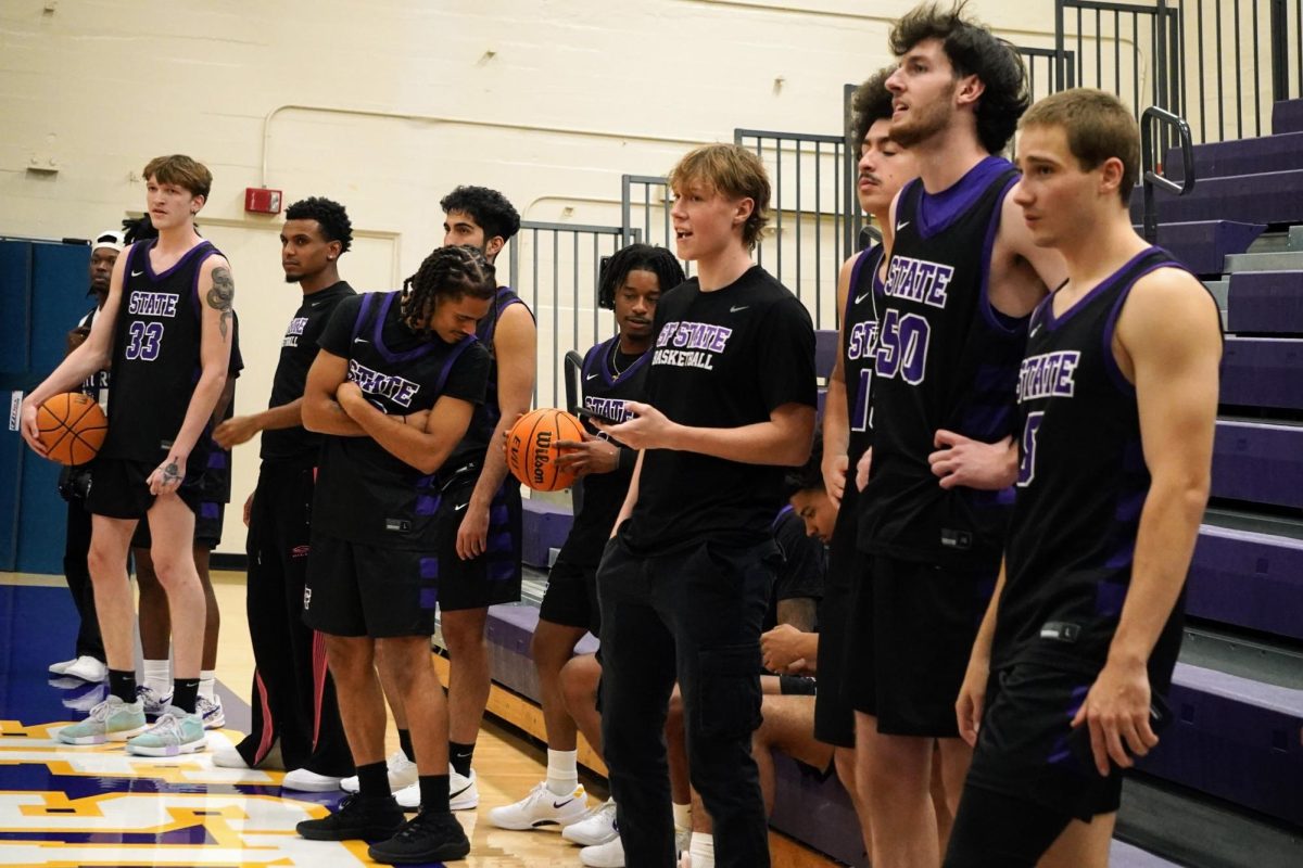 The men’s basketball team watches the dunk contest during Midnight Madness in the Main Gym on Friday, Oct. 25, 2024. (Neal Wong / Golden Gate Xpress)