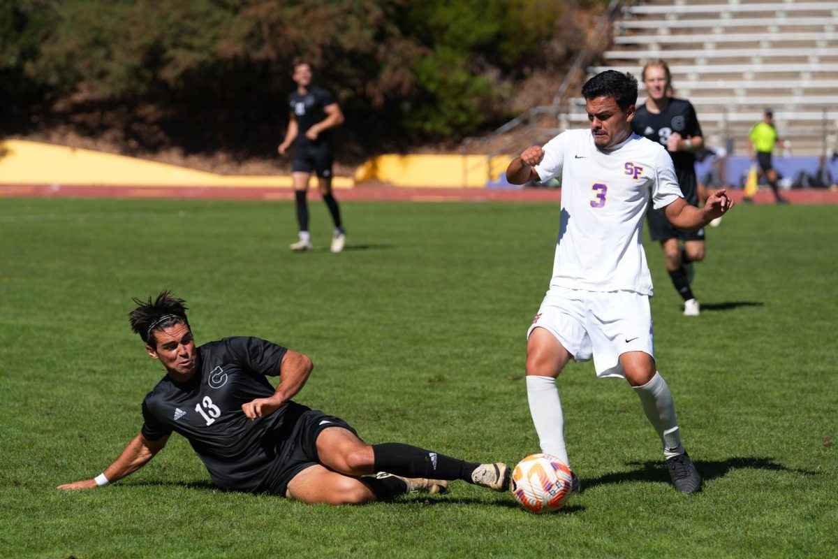 Dawson White, a junior defender from Chico State, attempts to steal the ball from Johan Duenas, a senior defender from San Francisco State University, during the schools’ matchup at Cox Stadium on Friday, Oct. 11, 2024. (Andrew Fogel / Golden Gate Xpress)