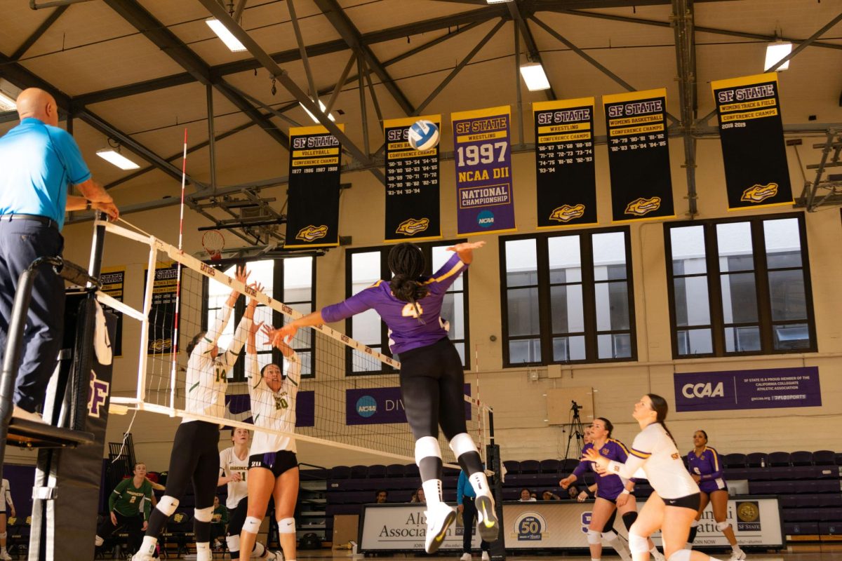 Alhana Velasquez (4) of SFSU attempts to strike the ball against Sarah Ybarra (14) and Helen McMullin (20) of Cal Poly Pomona in the gym at SFSU on Sunday, Nov. 17, 2024. (Jesus Arriaga / Golden Gate Xpress)