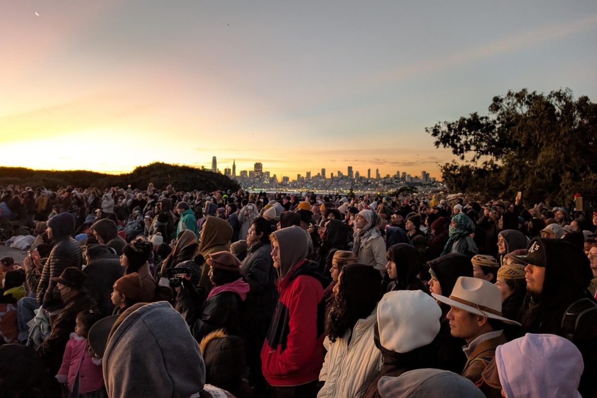 Thousands who attended the Thanksgiving Sunrise Gathering watched performances as the sun rose over on Alcatraz Island on Thursday, Nov. 28, 2024. (Neal Wong / Golden Gate Xpress)