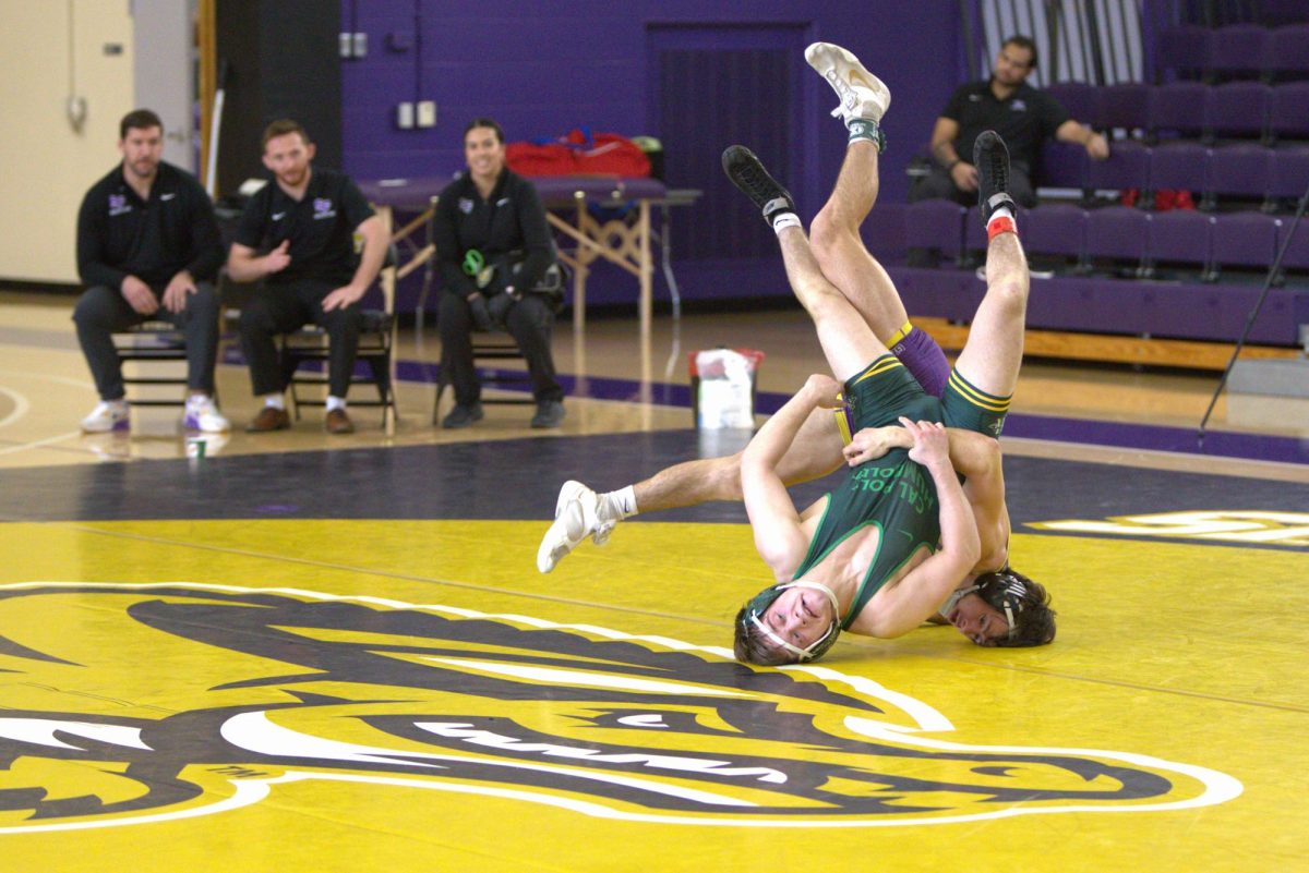 Senior Sean Yamasaki takes down Gil Mossburg of Cal Poly Humboldt during their home match in the Gymnasium on Feb. 8, 2025. Yamasaki won the bout by major decision, 13-3. (Seamus Geoghegan / Golden Gate Xpress)