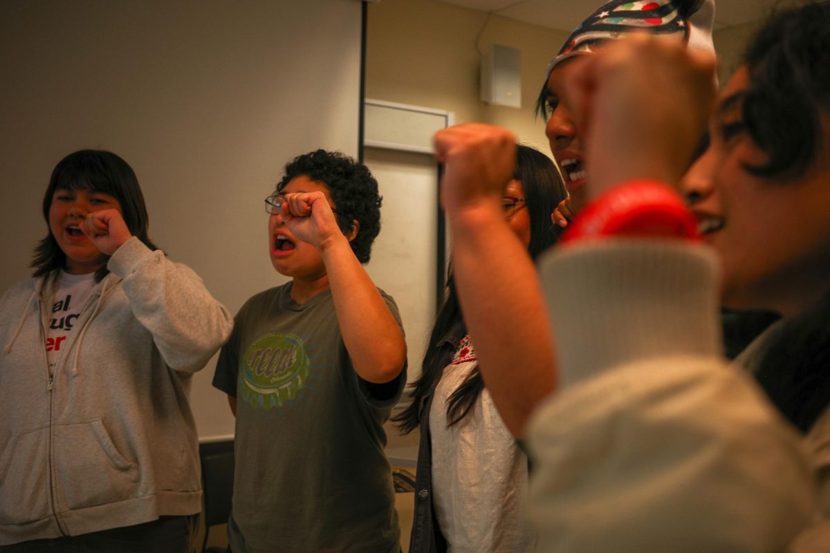 Members of the panel raise their fists in solidarity alongside attendees while chanting during the conference in Burk Hall on Wednesday, Sept. 17, 2025. (Courtesy of Jakob Porras)